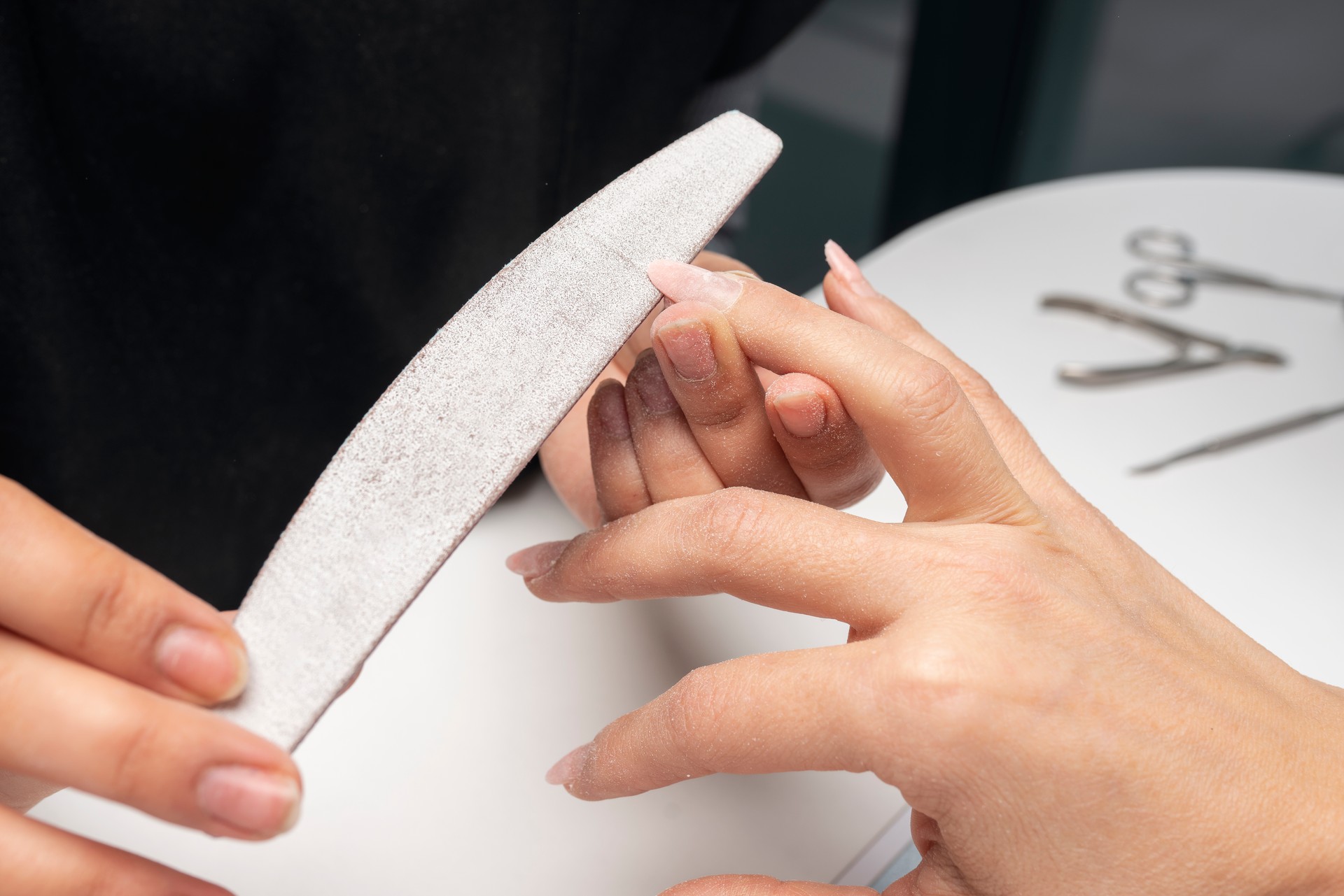 The manicurist is making new nails. Manicure. Beauty treatment and hand care